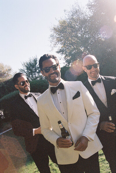 groom cheersing with his groomsmen at his wedding