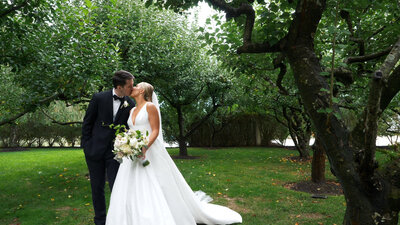 Bride and groom kissing in the grounds of  Bedell Cellars Long Island New York
