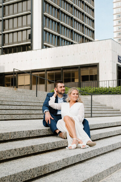 couple sitting on steps by nashville engagement photographer