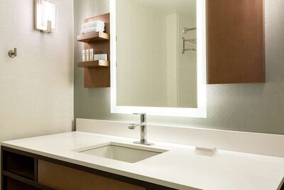 Modern hotel guest bathroom with LED mirror