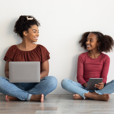 mom and daughter smiling at each other while sitting on the floor, hypnotherapy based programs for moms 