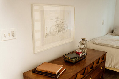 photo of desk with books and photo on the wall