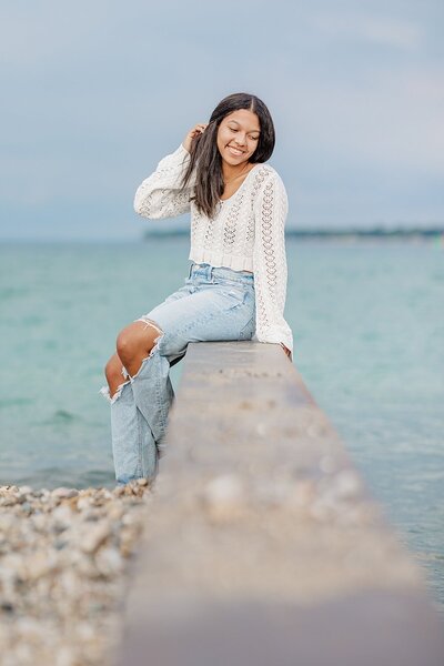 Senior sitting on breaker wall at Lighthouse Beach