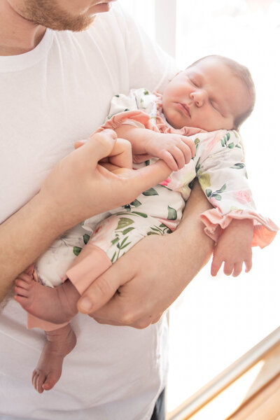 Photo of Dad holding newborn baby | Newborn Photography Session