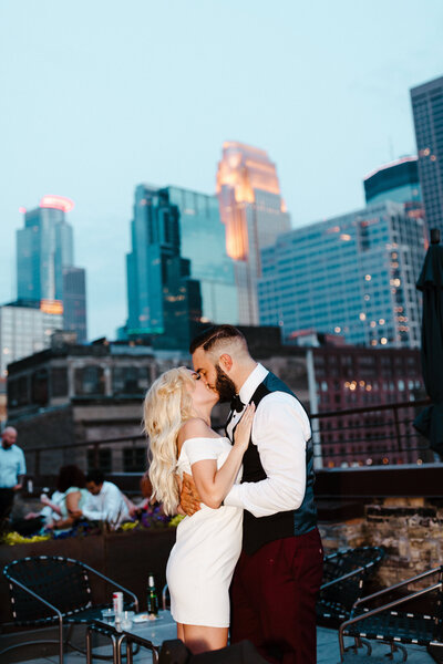 Bride and groom kissing at their reception during blue hour