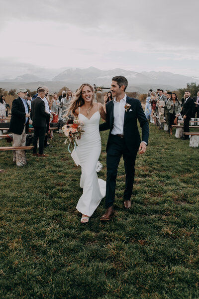 bride and groom by barn