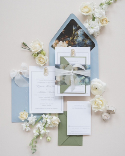 Single invitation with a thin vellum belly band wrapped around the middle