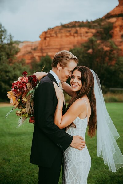 bride and groom smiling at enchantment resort in sedona