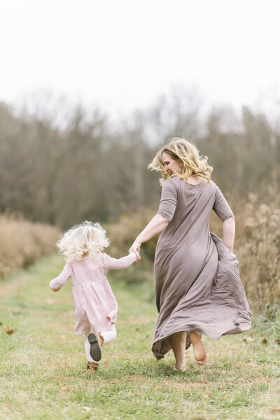 Mother and daughter running by Winston-Salem Photographer