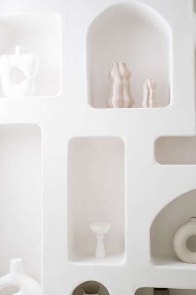 Interior shelves and ornaments in shades of white .