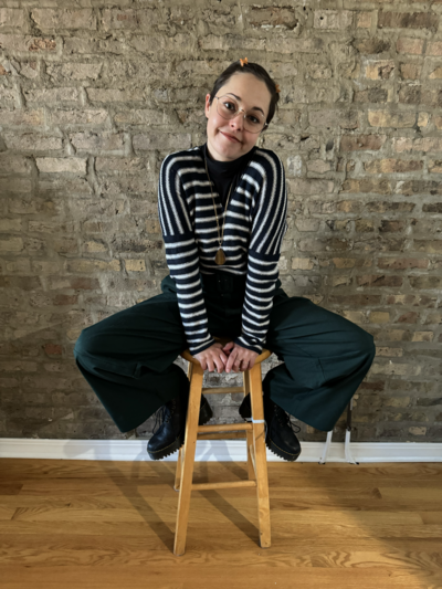 Lauren sitting on stool grinning