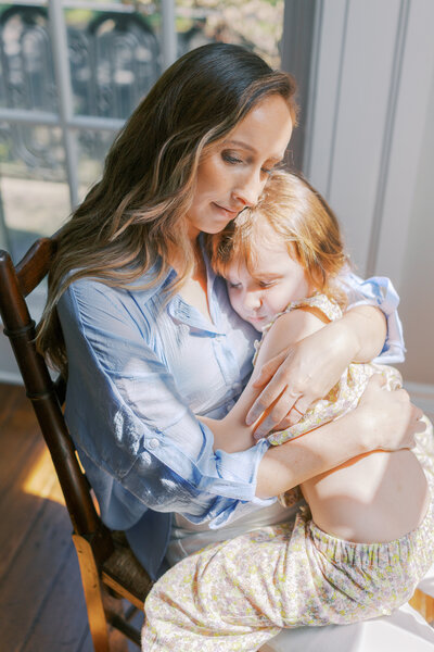 Warm light woman holding beautiful baby photoshoot