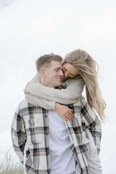 engagement session at the Beach in Miami couple in love hugging with Sandra vallejo Photography