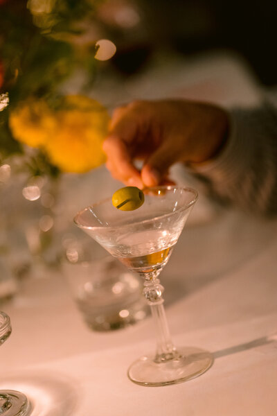 white flowers and white candles in small vases on a black table