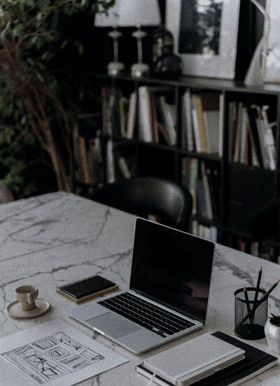 Modern branding workspace with brand deck and coffee, reflecting strategy and style for real estate brands.