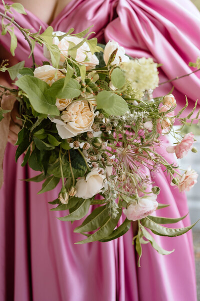 White wedding cake decorated with flowers and greenery