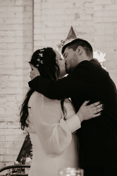 kiss at reception of wedding