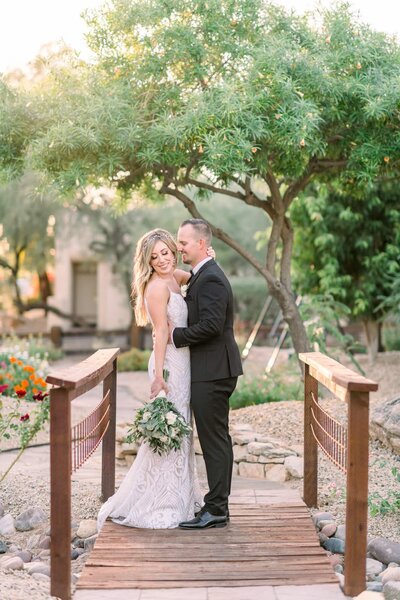 Wedding at JW Marriott Camelback Bride and Groom on wood bridge