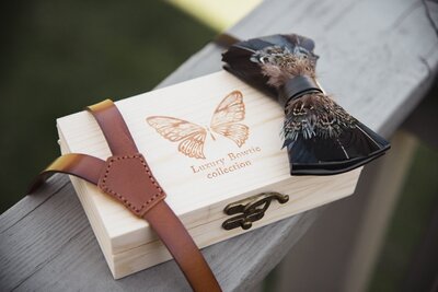 Wooden box with butterfly design and bow tie.