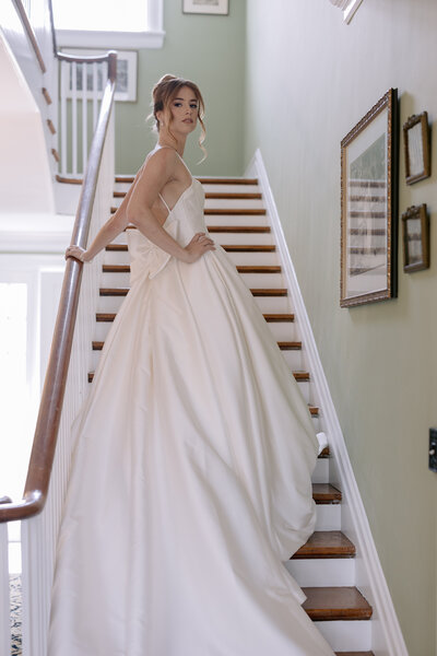 bride standing on stairs in her wedding gown