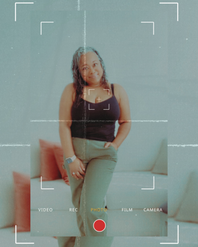 Letitia Hopkins standing confidently yet casual in her office, embodying self-love, personal growth, and Main Character Energy as a confidence and empowerment coach helping women create aligned, fulfilled lives.