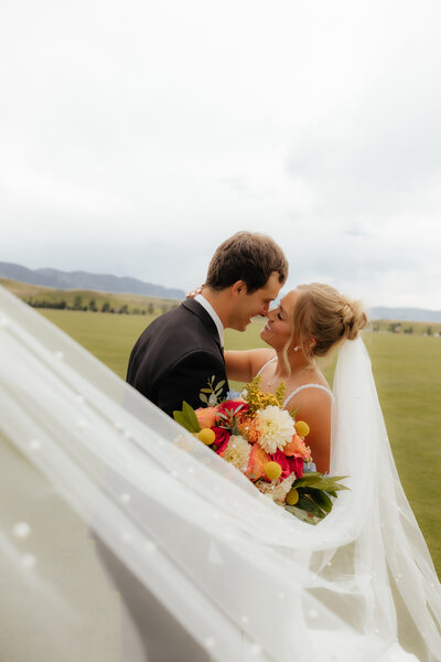 Engagement photo of a couple at sunset in Wyoming, with a romantic outdoor setting and soft natural lighting.