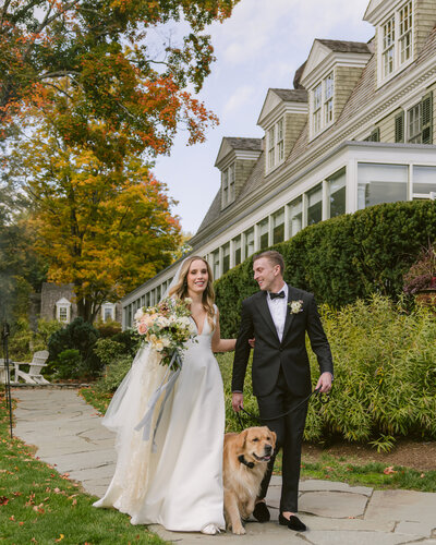 Couple at their New England wedding with their dog,