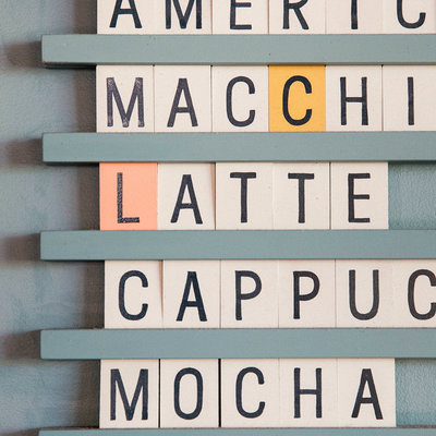 Scrabble letters spelling out Americano, Macchiato, Latte, Cappuccino and Mocha
