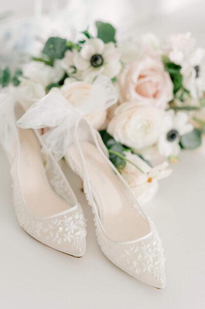 Bella Belle wedding shoes in front of pink and white bridal bouquet