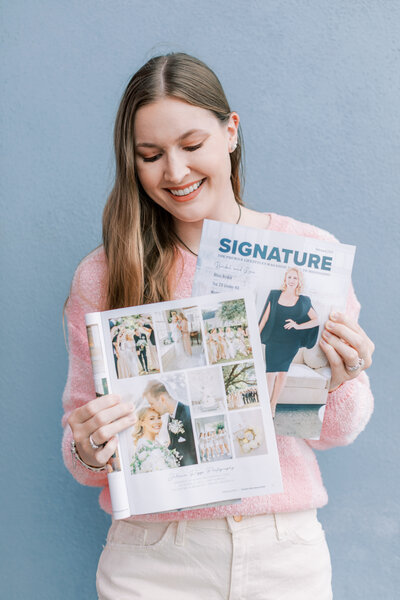 Juliann Riggs holds a Signature Magazine.