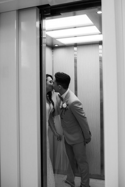Bride and groom kisses inside an elevator in Etre Farms, St. Jospeph, Michigan