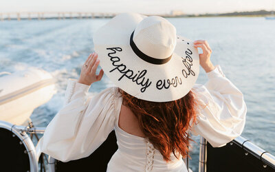 Hat detail on a bride on a yacht that says Happily Ever After at a Treasure Coast wedding afterparty on the water