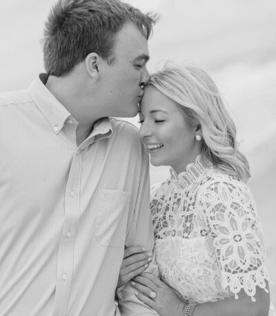 Man kissing woman's forehead