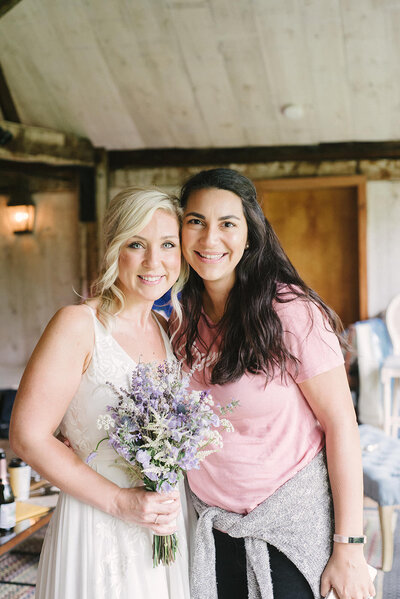 Jessica, of Crossed Keys Estate team, smiles with bride holding bouquet