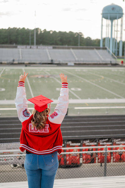 Social Circle High School senior looks out into the football field. Senior photography by Amanda Touchstone