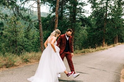 Candid photo of couple looking at their outfits after first look