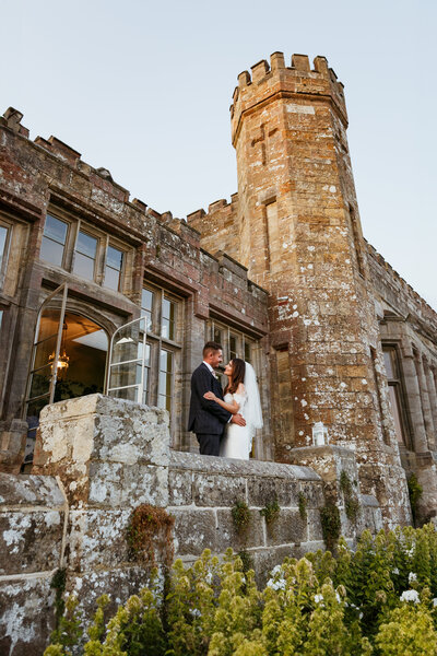 bride & groom posing at Wadhurst Castle