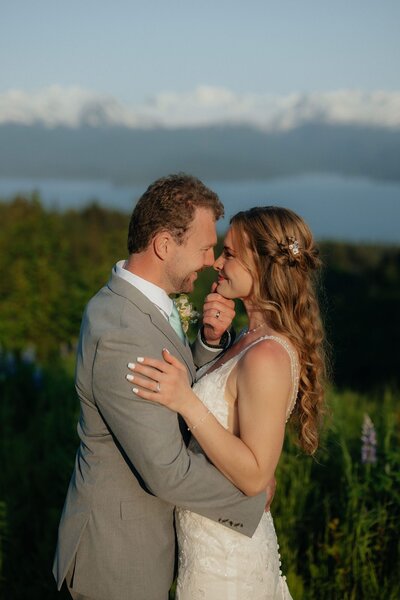 couple stands together at sunset