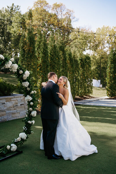 Bride hugging groom by Minnesota Wedding Photographer, Kelly Friday Photography. 