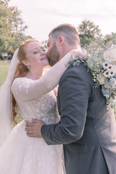 Groom giving the bride a kiss