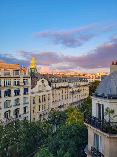 Golden light over classic Haussmann buildings and tree-lined streets in Paris, France ©Stephanie Dosch | theViatrix Paris Private Travel