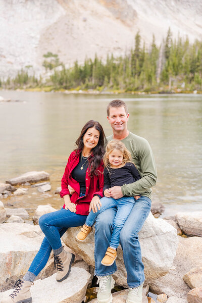 Family of 3 posing at their family session in the Snowy Range Mountains near Laramie, Wyoming.