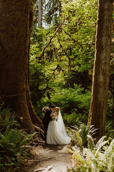 Oregon bride dipping toes in ocean at sunset