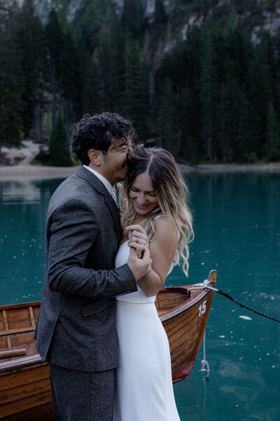 Editorial shot of the couple against a serene lake backdrop.
