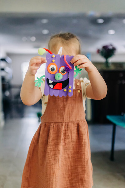 Little girl playing with art project in her home in st. pete fl
