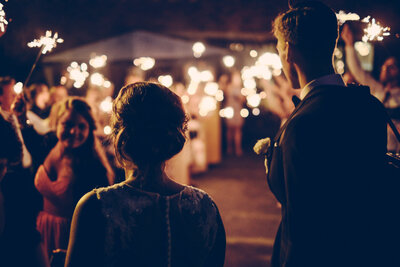 couple walking toward wedding reception on wedding night