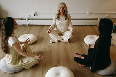 Janna Weldum of Eagle's Guiding Light sits in a circle guiding a group through a meditative circle at The Eyrie.