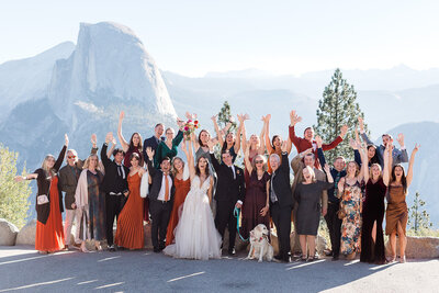 A small group of family and friends cheer for a bride and groom at their Yosemite wedding. 