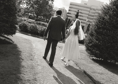bride and groom walking through a park in Downtown Calgary