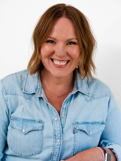 Headshot of Sally Martinez in a white shirt smiling at camera